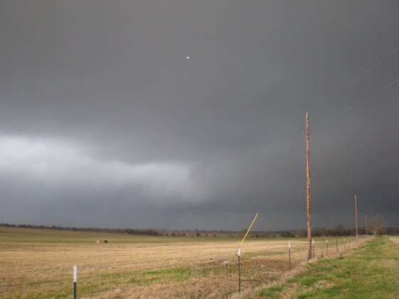 Large clear slot visible on the left, with a rain wrapped wall cloud.  This picture was taken one minute before the tornado became visible.