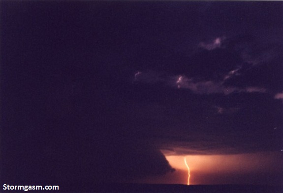 Wall cloud illuminated by lightning from a supercell in extreme southern Kansas on April 17, 2002.